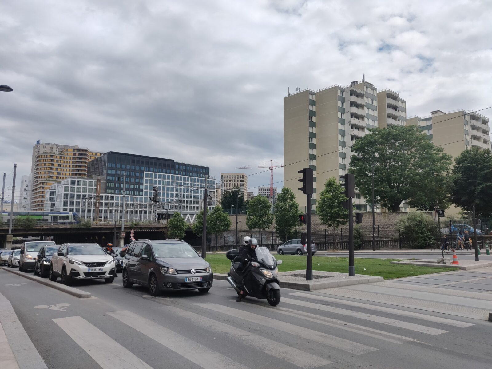 GrandParis Paris Statione Diane Airbus, Straße mit viel Verkehr, öffentlicher Raum, Zebrastreifen, Rollerfahrer, Stadt-Mensch Beziehung, Hochhäsuer Neubauten La Chapelle, neben Bahntrasse, 18. Bezirk,